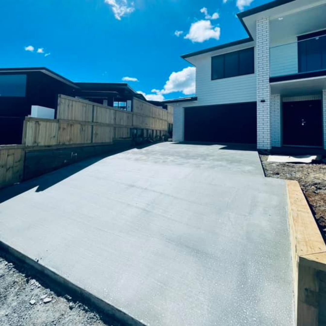 Freshly poured concrete driveway at a modern two-storey Auckland home