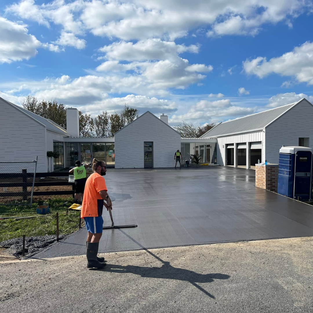 Slab Lab worker floating a large freshly poured concrete forecourt