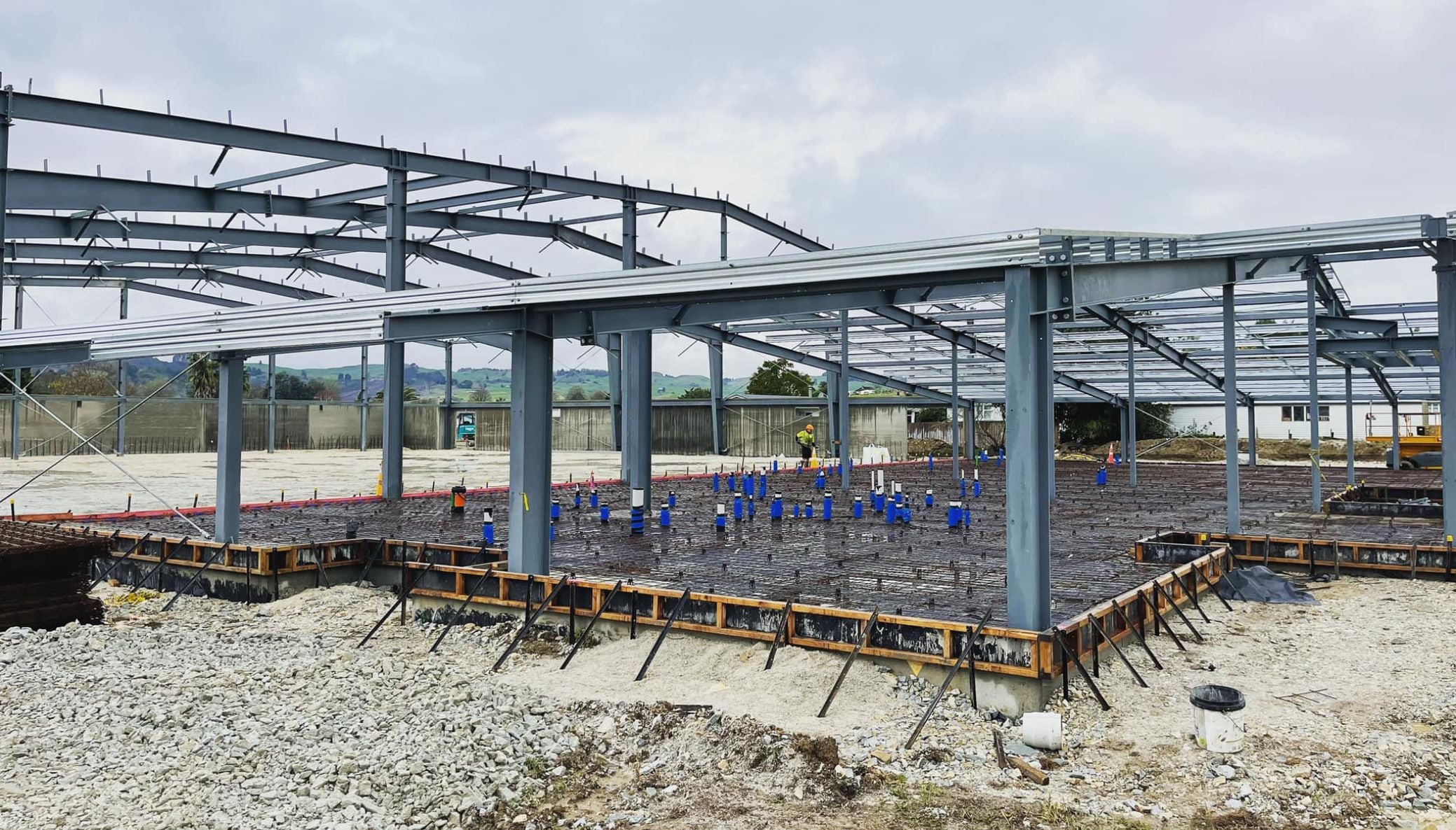 Steel frame of a commercial building under construction on a concrete slab
