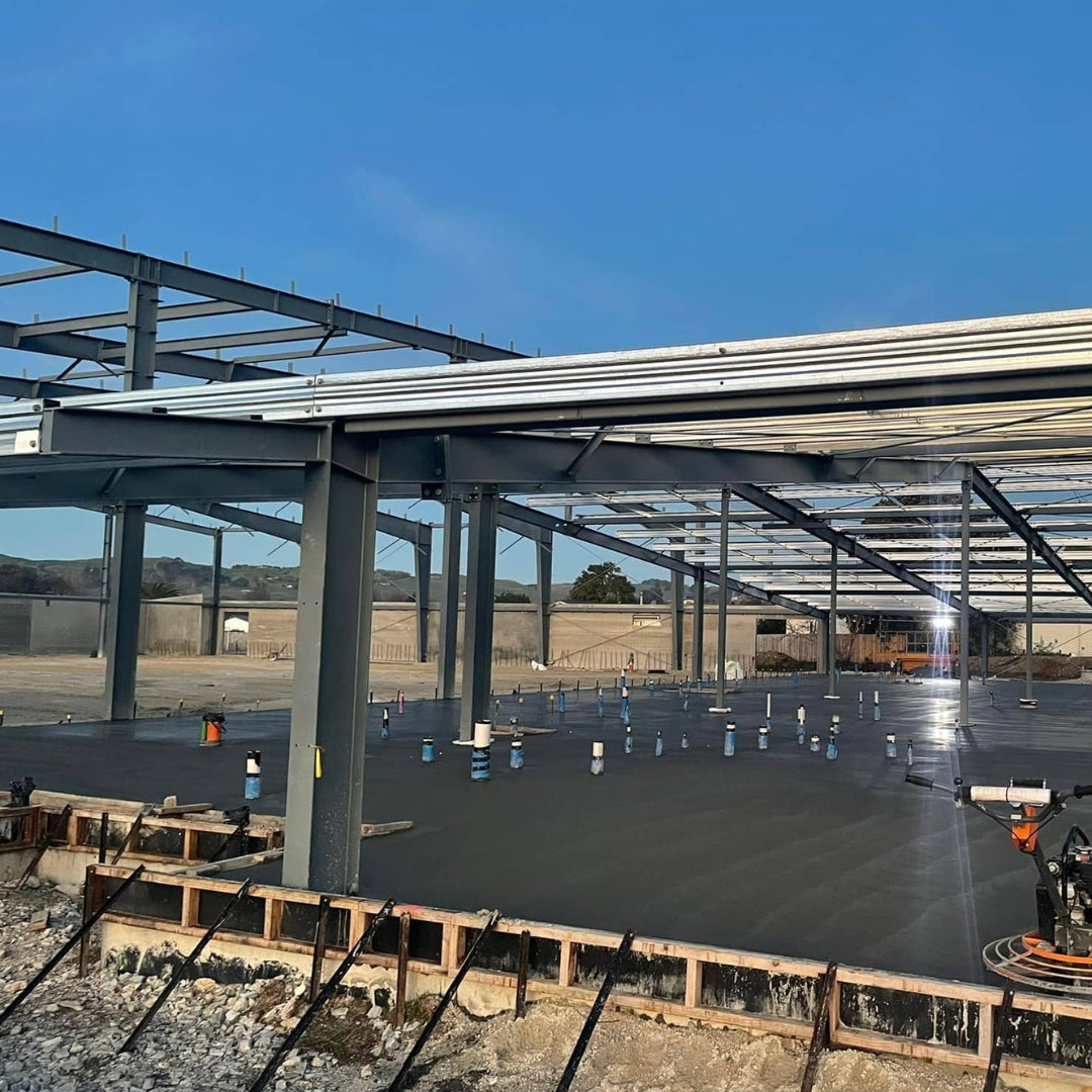 Concrete slab floor poured inside a steel-framed commercial building