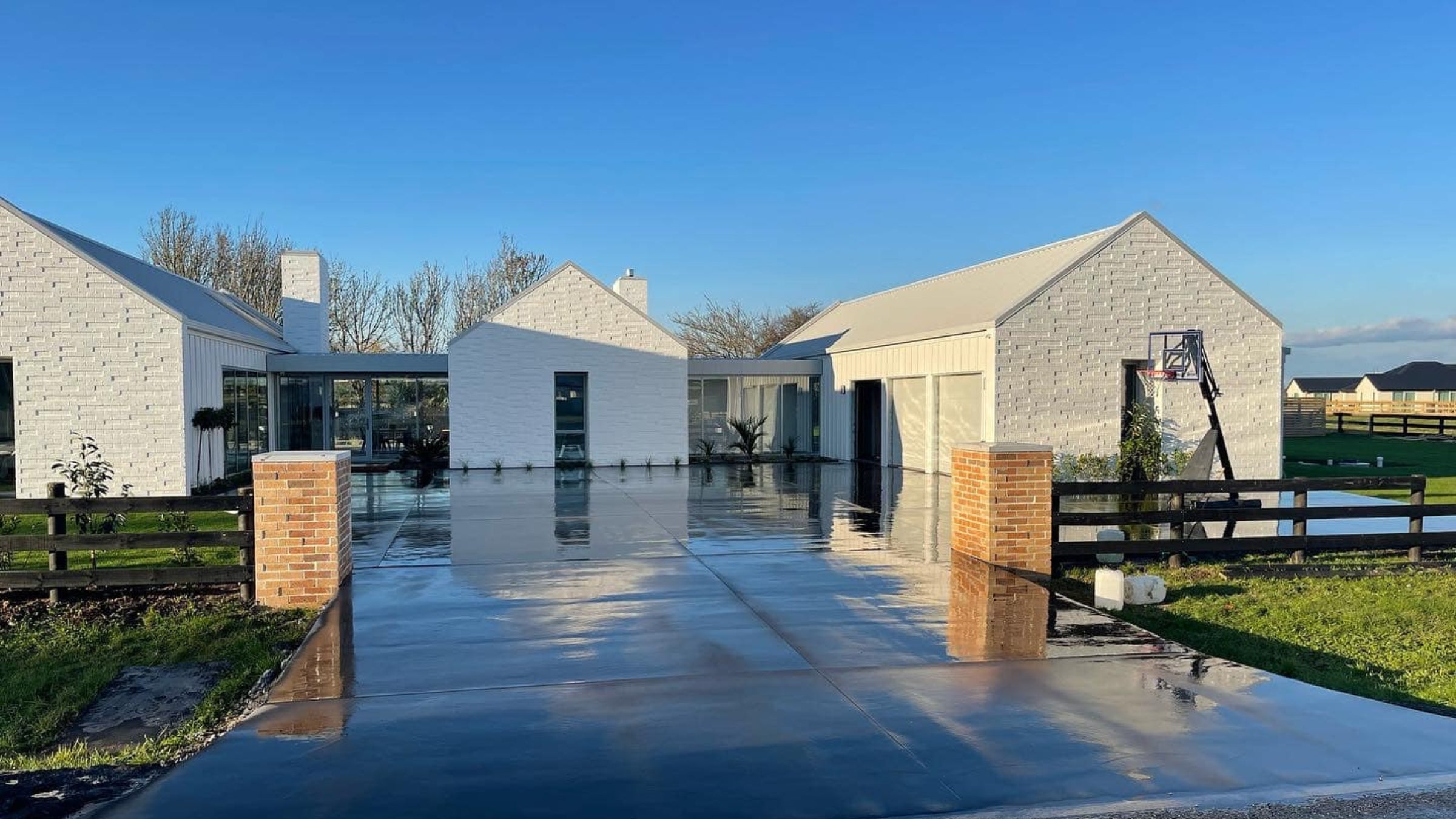 Freshly poured concrete forecourt in front of new white buildings